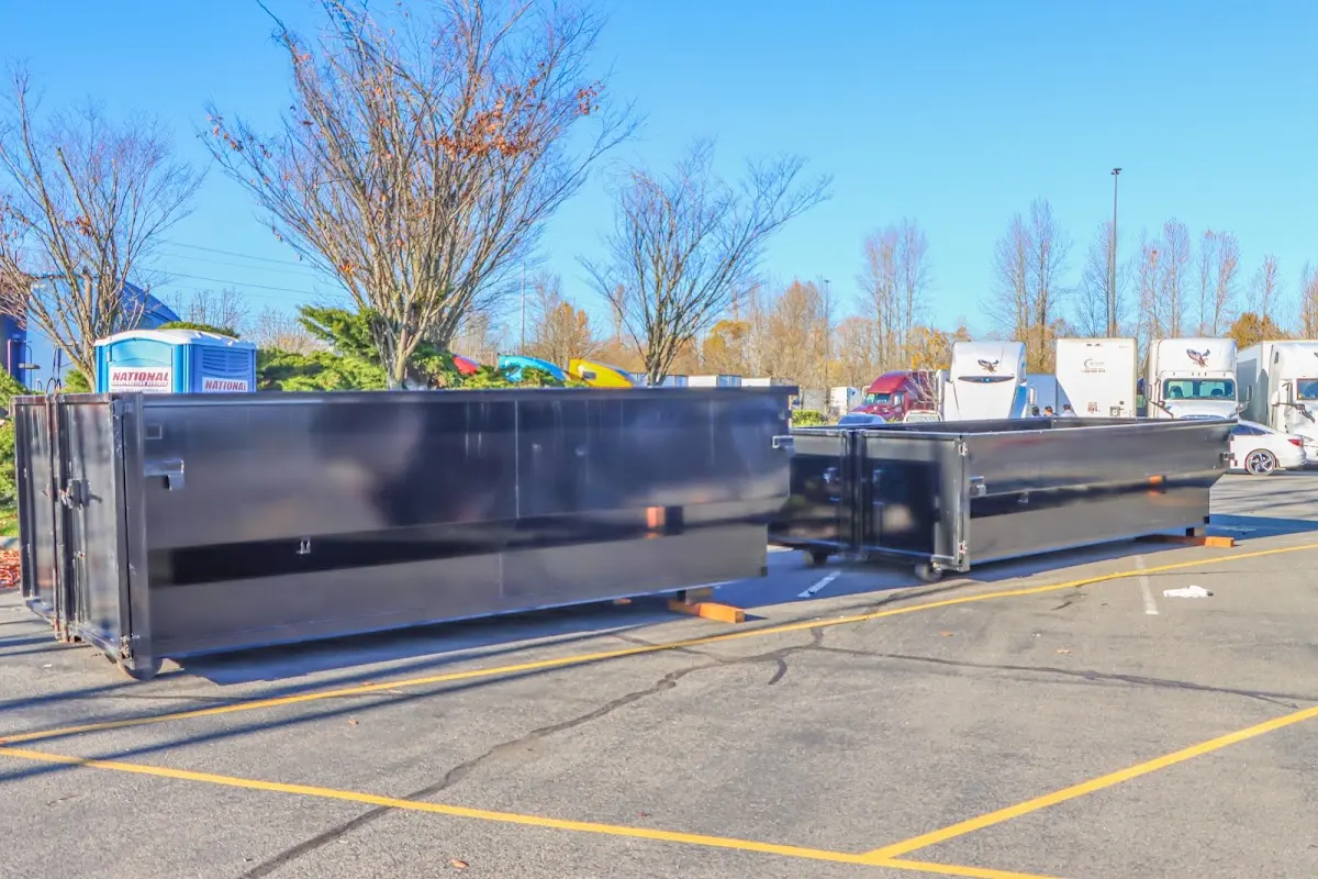 Professional dumpster rental service with roll-off container on residential driveway in Jensen Beach